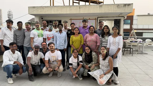 Team group photo after Holi celebrations on the rooftop