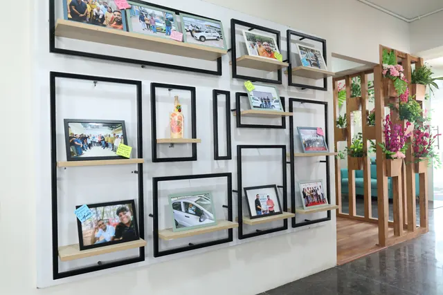 Photo wall of team moments at the LetzRyd office