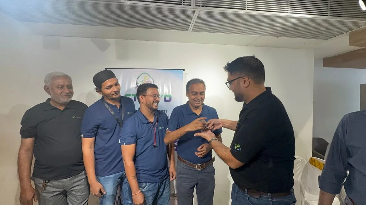 The LetzRyd team handing a driver-partner his keys at an office handover event