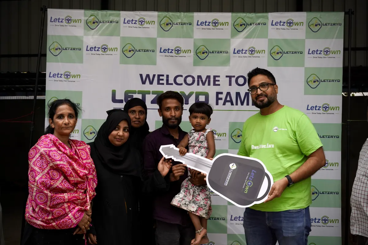 A driver-partner's family at the vehicle handover