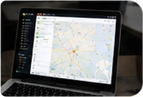 Laptop showing live vehicle tracking on a city map